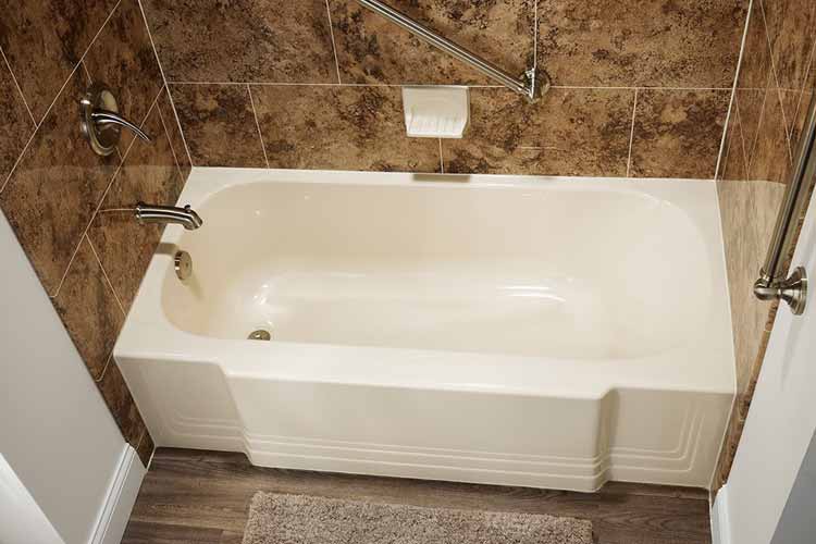 bath with tile walls