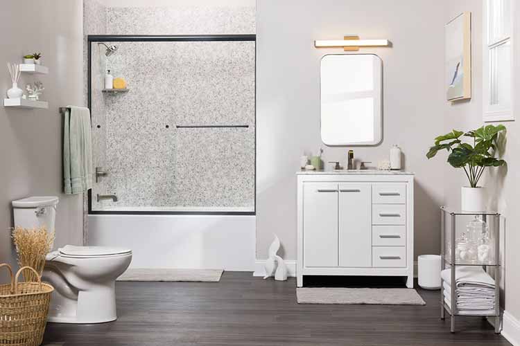 bath with glass barrier and gray texture wall