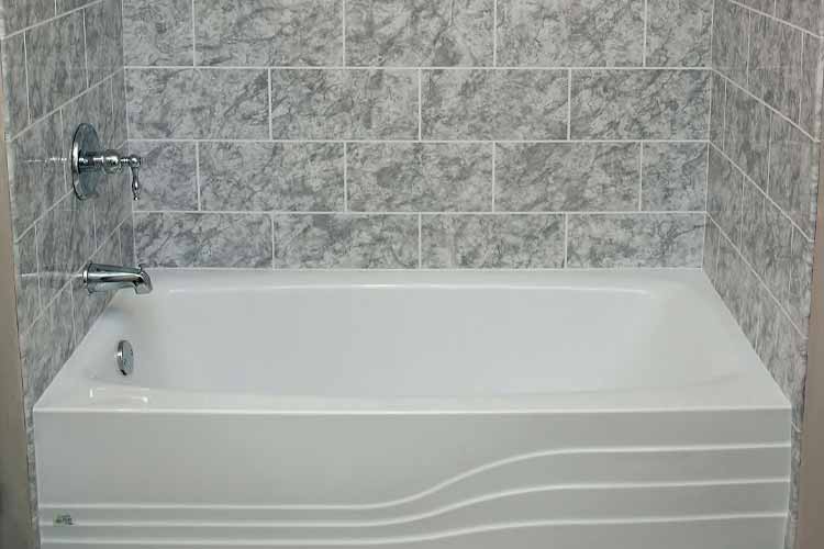 white bath with gray texture tiled walling