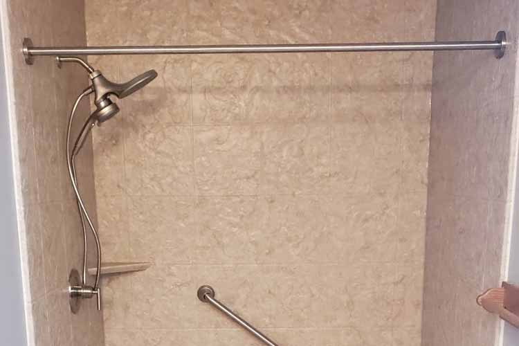 shower with tile wall